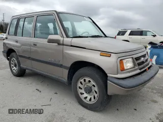 1997 Suzuki Sidekick JX z VIN 2S3TD03V4V6403519, wystawiony jako Copart lot #49666085 z przebiegiem 54 577 mil mil oraz Szkoda całkowita • Salvage title. Historia ofert i sprzedaży dostępna na DreamBid. Obrazek 4.