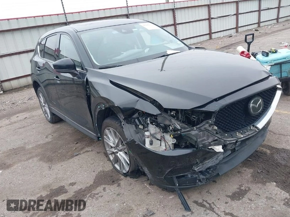 2020 Mazda CX-5 Grand Touring with VIN JM3KFADM8L0811910, listed as a IAAI auction lot 41446214 with 57,849 mi miles. Bid and sale history available at carsss.com. Image 1.