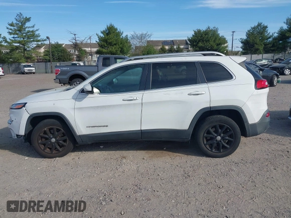 2015 Jeep Cherokee Latitude with VIN 1C4PJLCS6FW689607, listed as a IAAI auction lot 42103286 with 142,479 mi miles. Bid and sale history available at carsss.com. Image 14.