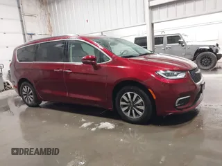 2021 Chrysler Pacifica Hybrid Touring L with VIN 2C4RC1L71MR581260, listed as a IAAI auction lot 42014401 with 68,719 mi miles and . Bid and sale history available at DreamBid. Image 13.