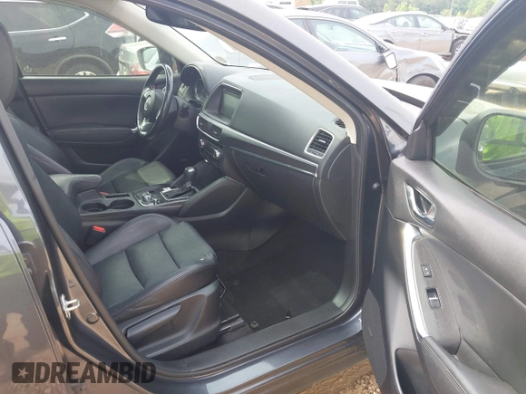 2016 Mazda CX-5 Grand Touring z VIN JM3KE2DY5G0801238, wystawiony jako IAAI lot #42264694 z przebiegiem 136 993 mil mil oraz . Historia ofert i sprzedaży dostępna na DreamBid. Obrazek 5.