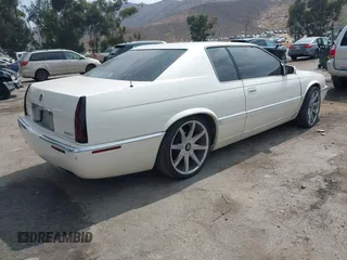 2002 Cadillac Eldorado ESC z VIN 1G6EL12Y92B100484, wystawiony jako IAAI lot #42418094 z przebiegiem 167 293 mil mil oraz . Historia ofert i sprzedaży dostępna na DreamBid. Obrazek 4.