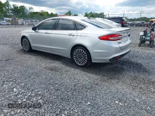 2017 Ford Fusion Titanium with VIN 3FA6P0K99HR112234, listed as a IAAI auction lot 42332700 with 106,685 mi miles and . Bid and sale history available at DreamBid. Image 3.