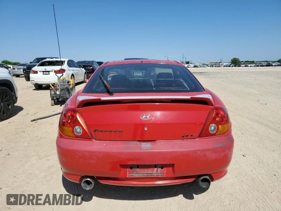 2003 Hyundai Tiburon GT z VIN KMHHN65F53U041351, wystawiony jako Copart lot #52332395 z przebiegiem 194 821 mil mil oraz Czysty tytuł • Clean title. Historia ofert i sprzedaży dostępna na DreamBid. Obrazek 6.