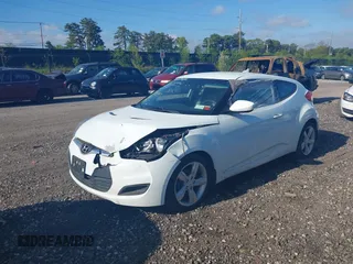 2013 Hyundai Veloster w/Gray Int with VIN KMHTC6AD2DU115735, listed as a IAAI auction lot 39404347 with 166,840 mi miles and . Bid and sale history available at DreamBid. Image 2.