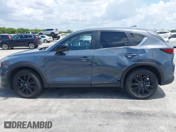 2024 Mazda CX-5 S Carbon Edition z VIN JM3KFBCLXR0521353, wystawiony jako IAAI lot #42351444 z przebiegiem 17 270 mil mil oraz . Historia ofert i sprzedaży dostępna na DreamBid. Obrazek 6.
