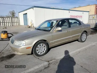 2002 Kia Optima LX z VIN KNAGD126X25156415, wystawiony jako Copart lot #80253444 z przebiegiem 104 775 mil mil oraz Szkoda całkowita • Salvage title. Historia ofert i sprzedaży dostępna na DreamBid. Obrazek 1.