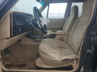 1996 Jeep Cherokee Sport with VIN 1J4FJ68S0TL288244, listed as a Copart auction lot 87801025 with 218,356 mi miles and Salvage Title. Bid and sale history available at carsss.com. Image 7.