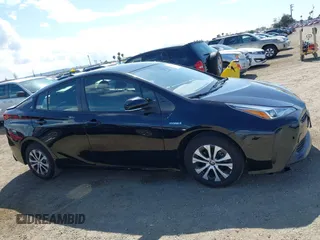 2021 Toyota Prius L Eco with VIN JTDKAMFU6M3135799, listed as a IAAI auction lot 42064241 with 77,120 mi miles and . Bid and sale history available at DreamBid. Image 13.