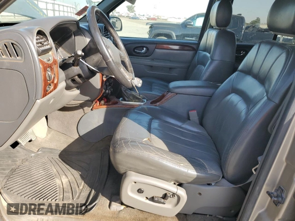 2003 GMC Envoy SLE with VIN 1GKDS13S332390989, listed as a Copart auction lot 74729104 with 127,680 mi miles and Salvage Title. Bid and sale history available at DreamBid. Image 7.