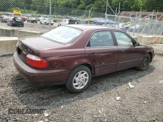 2000 Mazda 626 LX z VIN 1YVGF22C4Y5112874, wystawiony jako Copart lot #58952175 z przebiegiem 100 070 mil mil oraz Szkoda całkowita • Salvage title. Historia ofert i sprzedaży dostępna na DreamBid. Obrazek 3.