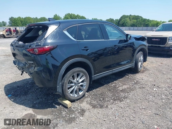 2020 Mazda CX-5 Grand Touring with VIN JM3KFADM9L1837183, listed as a IAAI auction lot 42340628 with 81,975 mi miles and . Bid and sale history available at DreamBid. Image 4.