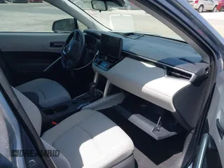 2023 Toyota Corolla Cross LE with VIN 7MUCAAAGXPV045651, listed as a IAAI auction lot 42006289 with 23,282 mi miles and . Bid and sale history available at DreamBid. Image 5.