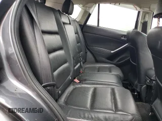 2016 Mazda CX-5 Grand Touring z VIN JM3KE4DY5G0741800, wystawiony jako Copart lot #58565455 z przebiegiem 33 675 mil mil oraz Szkoda całkowita • Salvage title. Historia ofert i sprzedaży dostępna na DreamBid. Obrazek 11.
