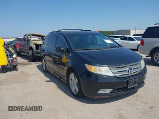2011 Honda Odyssey Touring with VIN 5FNRL5H97BB089889, listed as a IAAI auction lot 42211791 with 201,766 mi miles and . Bid and sale history available at DreamBid. Image 1.