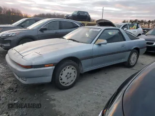 1986 Toyota Supra z VIN JT2MA70L4G0016772, wystawiony jako Copart lot #85806484 z przebiegiem 128 504 mil mil oraz Czysty tytuł • Clean title. Historia ofert i sprzedaży dostępna na DreamBid. Obrazek 1.