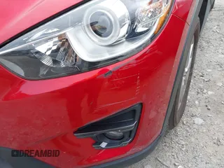 2016 Mazda CX-5 Touring z VIN JM3KE2CY3G0894441, wystawiony jako IAAI lot #41508767 z przebiegiem 88 554 mil mil oraz . Historia ofert i sprzedaży dostępna na DreamBid. Obrazek 20.