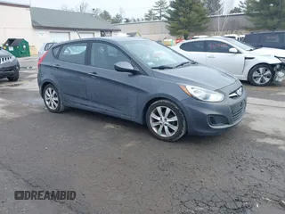 2012 Hyundai Accent SE with VIN KMHCU5AE4CU037411, listed as a IAAI auction lot 41659662 with 163,021 mi miles. Bid and sale history available at carsss.com. Image 1.
