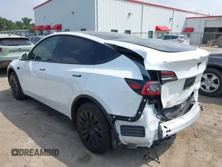 2023 Tesla Model Y Long Range with VIN 7SAYGAEEXPF776370, listed as a IAAI auction lot 42127512 with 27,120 mi miles and . Bid and sale history available at DreamBid. Image 3.