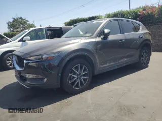 2018 Mazda CX-5 Grand Touring with VIN JM3KFADM3J1389911, listed as a Copart auction lot 60530295 with 103,177 mi miles and Salvage title. Bid and sale history available at DreamBid. Image 1.