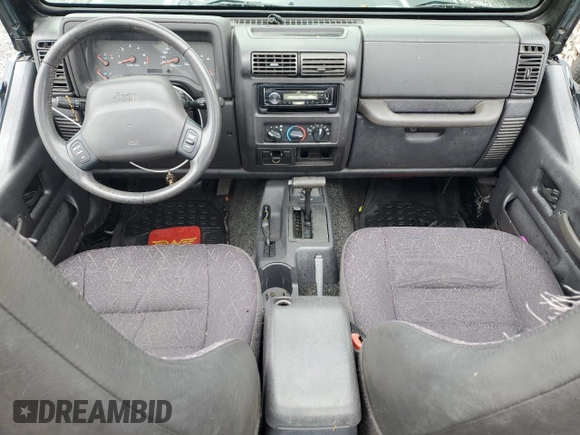 2002 Jeep Wrangler Sport with VIN 1J4FA49S12P730135, listed as a Copart auction lot 54477835 with 148,153 mi miles and Salvage title. Bid and sale history available at DreamBid. Image 8.