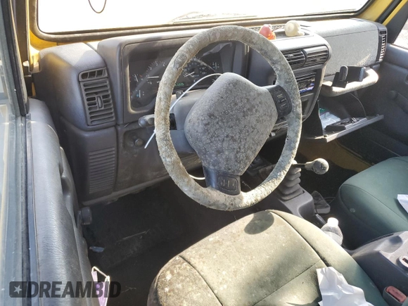 2000 Jeep Wrangler Sport with VIN 1J4FA49SXYP745676, listed as a Copart auction lot 63096755 with 147,226 mi miles and Salvage title. Bid and sale history available at DreamBid. Image 8.