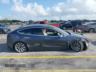 2020 Tesla Model 3 Standard Range Plus with VIN 5YJ3E1EA0LF744046, listed as a IAAI auction lot 41939894 with 102,576 mi miles. Bid and sale history available at carsss.com. Image 13.