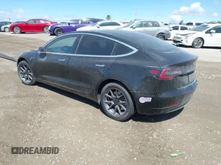 2019 Tesla Model 3 Mid Range with VIN 5YJ3E1EA3KF325056, listed as a IAAI auction lot 41771543 with 183,157 mi miles and . Bid and sale history available at carsss.com. Image 3.