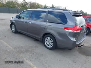 2014 Toyota Sienna XLE with VIN 5TDYK3DC7ES517206, listed as a IAAI auction lot 41945572 with 128,743 mi miles and . Bid and sale history available at DreamBid. Image 3.