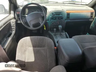 1999 Jeep Grand Cherokee Laredo with VIN 1J4GW58S1XC775877, listed as a Copart auction lot 55639795 with 197,611 mi miles and Salvage title. Bid and sale history available at DreamBid. Image 8.