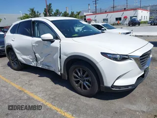2020 Mazda CX-9 Sport z VIN JM3TCABY1L0406720, wystawiony jako IAAI lot #42304144 z przebiegiem 75 887 mil mil oraz . Historia ofert i sprzedaży dostępna na DreamBid. Obrazek 1.