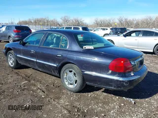 1999 Lincoln Continental with VIN 1LNHM97V8XY700644, listed as a IAAI auction lot 41641082 with 142,527 mi miles. Bid and sale history available at carsss.com. Image 3.