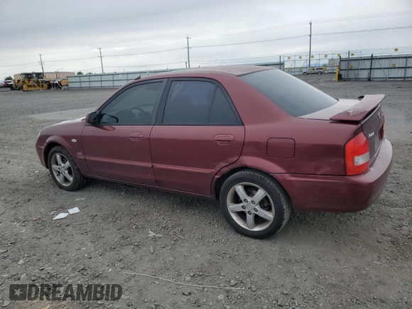 2002 Mazda Protege DX z VIN JM1BJ225320636991, wystawiony jako Copart lot #57915265 z przebiegiem 123 371 mil mil oraz Szkoda całkowita • Salvage title. Historia ofert i sprzedaży dostępna na DreamBid. Obrazek 2.