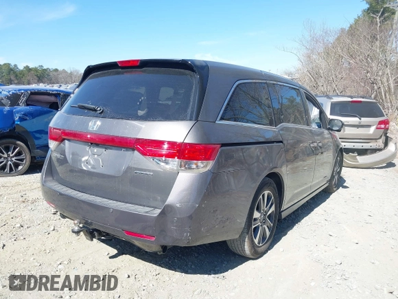 2014 Honda Odyssey Touring with VIN 5FNRL5H92EB016546, listed as a IAAI auction lot 41689148 with 143,601 mi miles and . Bid and sale history available at DreamBid. Image 4.