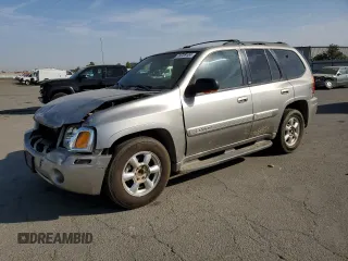 2003 GMC Envoy SLE with VIN 1GKDS13S332390989, listed as a Copart auction lot 74729104 with 127,680 mi miles and Salvage Title. Bid and sale history available at carsss.com. Image 1.