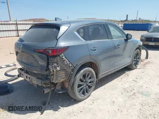 2023 Mazda CX-5 S Carbon Edition z VIN JM3KFBCM7P0164462, wystawiony jako IAAI lot #41919579 z przebiegiem 49 585 mil mil oraz . Historia ofert i sprzedaży dostępna na DreamBid. Obrazek 4.