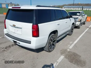 2015 Chevrolet Tahoe LT with VIN 1GNSCBKCXFR552071, listed as a IAAI auction lot 41972157 with 214,738 mi miles and . Bid and sale history available at DreamBid. Image 4.