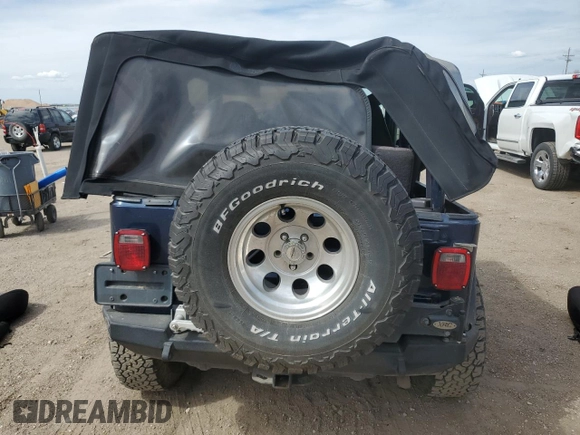 2002 Jeep Wrangler Sport z VIN 1J4FA49SX2P772609, wystawiony jako Copart lot #55893425 z przebiegiem 157 653 mil mil oraz Szkoda całkowita • Salvage title. Historia ofert i sprzedaży dostępna na DreamBid. Obrazek 6.