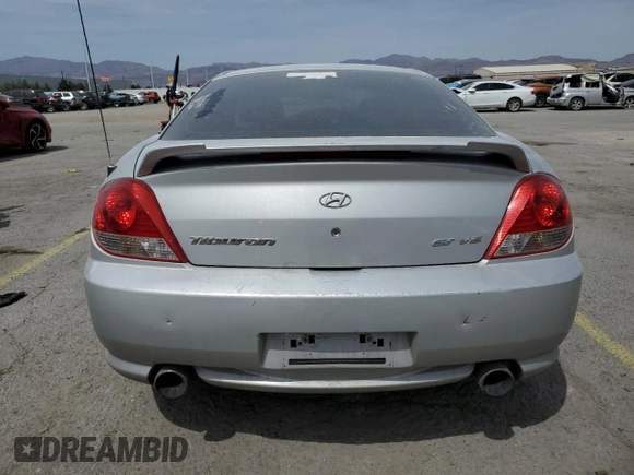 2006 Hyundai Tiburon GT z VIN KMHHN65F06U203701, wystawiony jako Copart lot #52374135 z przebiegiem 90 796 mil mil oraz Szkody całkowita. Historia ofert i sprzedaży dostępna na DreamBid. Obrazek 6.