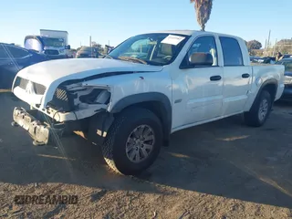 2006 Mitsubishi Raider Duro Cross with VIN 1Z7HC38K36S576409, listed as a IAAI auction lot 41410982 with 152,476 mi miles. Bid and sale history available at carsss.com. Image 2.