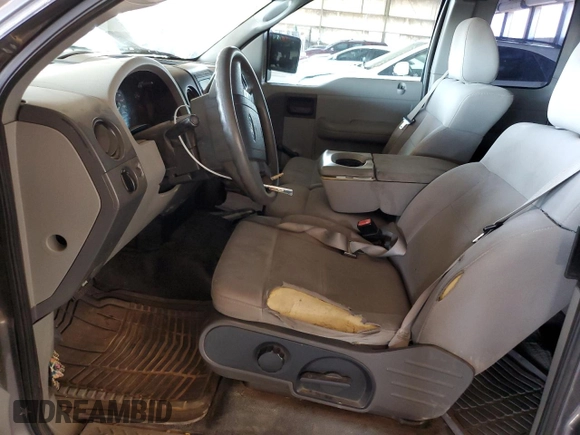 2005 Ford F-150 STX with VIN 1FTRX12W25NA37703, listed as a Copart auction lot 60089325 with 128,651 mi miles and Salvage title. Bid and sale history available at DreamBid. Image 7.