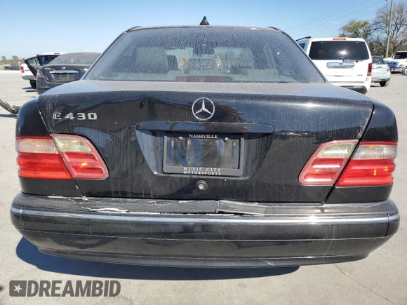 2000 Mercedes-Benz E-Class with VIN WDBJF70JXYB091085, listed as a Copart auction lot 77136484 with 185,429 mi miles and Salvage Title. Bid and sale history available at carsss.com. Image 6.