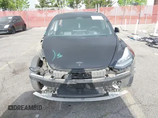 2019 Tesla Model 3 Mid Range with VIN 5YJ3E1EA3KF415601, listed as a IAAI auction lot 42125393 with 150,220 mi miles and . Bid and sale history available at carsss.com. Image 6.