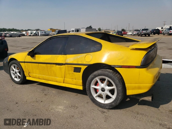 1986 Pontiac Fiero z VIN 1G2PG9796GP256622, wystawiony jako Copart lot #69203894 z przebiegiem 38 964 mil mil oraz Szkody całkowita. Historia ofert i sprzedaży dostępna na DreamBid. Obrazek 2.