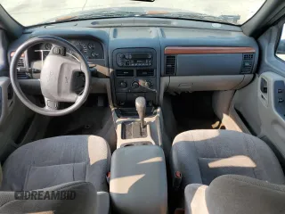 1999 Jeep Grand Cherokee Laredo with VIN 1J4G258S9XC731752, listed as a Copart auction lot 58601555 with 245,284 mi miles and Salvage title. Bid and sale history available at DreamBid. Image 8.