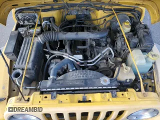2000 Jeep Wrangler Sport with VIN 1J4FA49SXYP745676, listed as a Copart auction lot 63096755 with 147,226 mi miles and Salvage title. Bid and sale history available at DreamBid. Image 12.