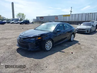 2019 Toyota Camry LE with VIN 4T1B11HK6KU276644, listed as a IAAI auction lot 42037249 with 23,677 mi miles and . Bid and sale history available at DreamBid. Image 2.