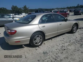 1999 Mazda Millenia z VIN JM1TA2217X1502746, wystawiony jako Copart lot #72165894 z przebiegiem 196 957 mil mil oraz Szkody całkowita. Historia ofert i sprzedaży dostępna na DreamBid. Obrazek 3.