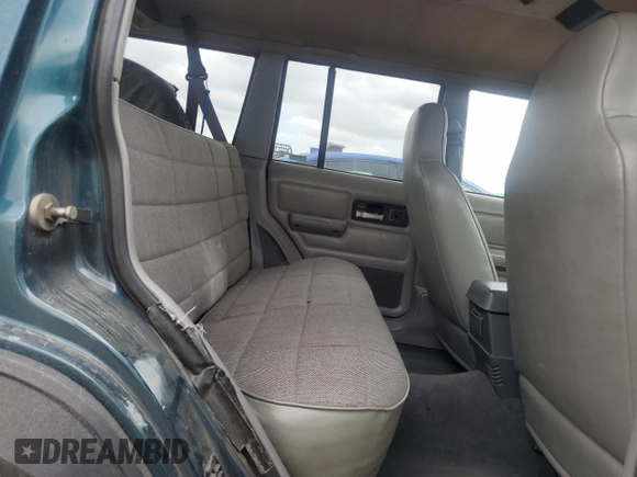 1996 Jeep Cherokee Sport with VIN 1J4FJ68S3TL251074, listed as a Copart auction lot 59593955 with 181,482 mi miles and Salvage title. Bid and sale history available at DreamBid. Image 11.