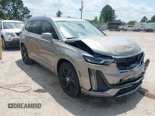 2022 Cadillac XT6 Premium Luxury z VIN 1GYKPCRS4NZ107852, wystawiony jako IAAI lot #42075012 z przebiegiem 66 046 mil mil oraz . Historia ofert i sprzedaży dostępna na DreamBid. Obrazek 1.